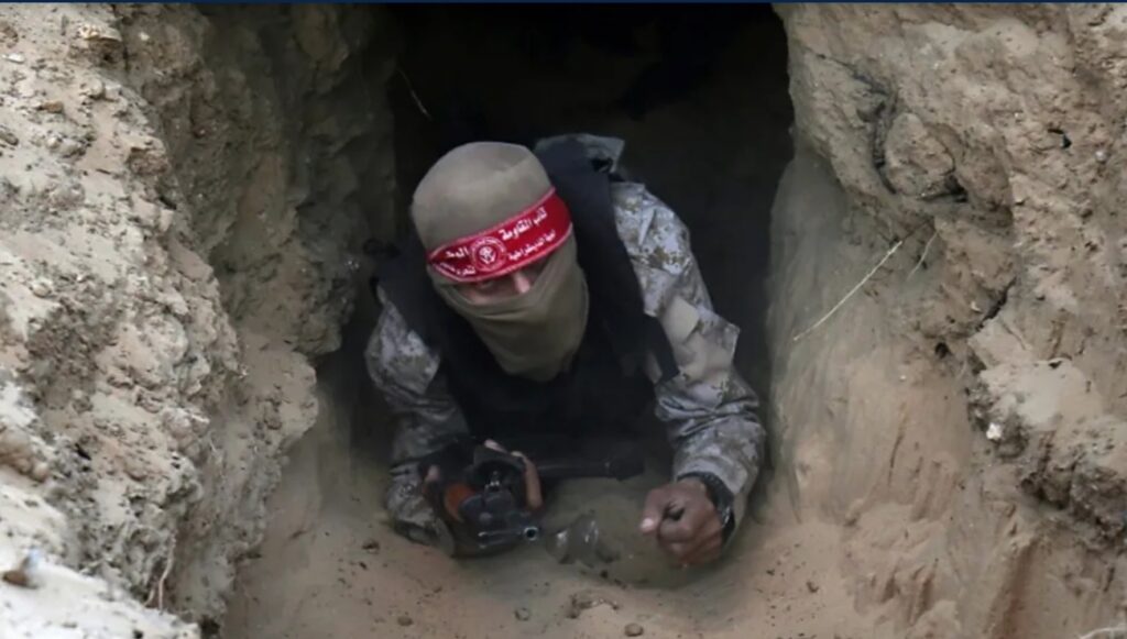 A Hamas fighter emerging from a Gaza tunnel.