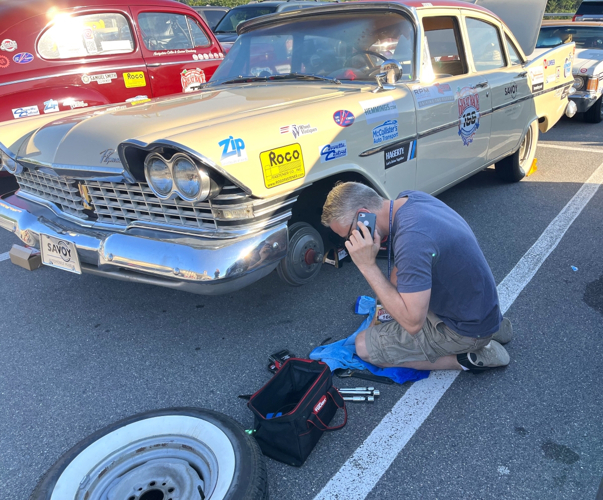 Photo of man changing tire during a Great Race