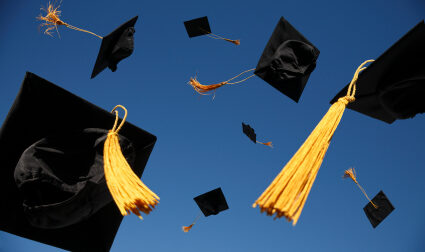 Graduation Caps thrown in sky photo
