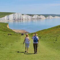 photo of couple walking down a path