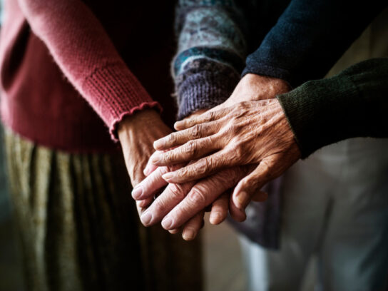 photo of closeup of hands of group of seniors