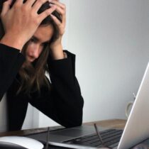 photo of stressed woman looking at laptop