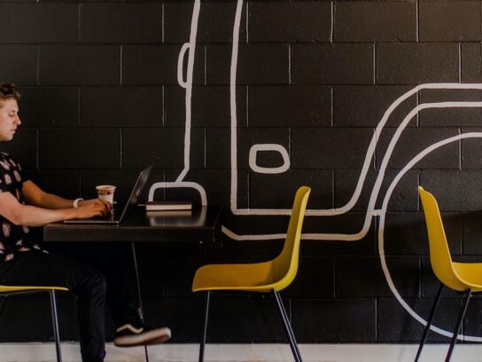 photo of man on laptop in a cafe