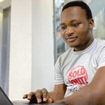 photo of man looking at laptop