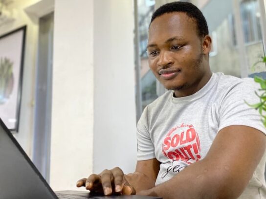 photo of man looking at laptop