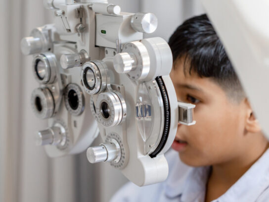 boy doing eye test exam