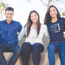 photo of diverse young adults sitting on a sofa