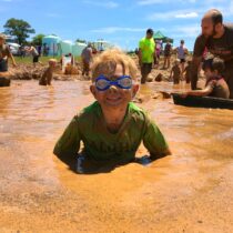 photo of boy enjoying mudfest event