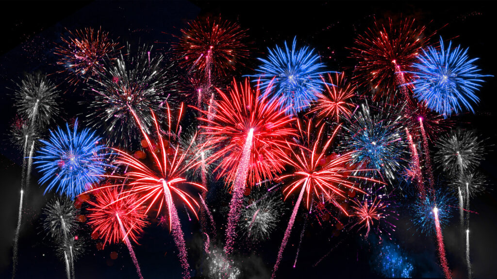 photo of red white and blue fireworks in night sky