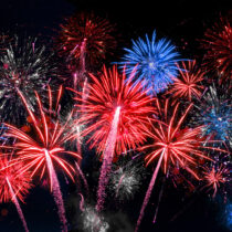 photo of red white and blue fireworks in night sky