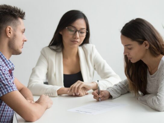 photo of young wife sign divorce papers in lawyer office