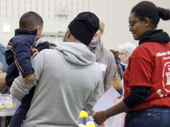 photo of families receiving assistance at Gaithersburg holiday giving program