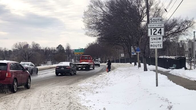 Main highways are clear, but many bus stops remain covered in snow, forcing riders to wait along the roadway.