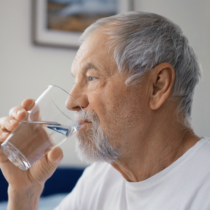 senior man drinking water in the morning