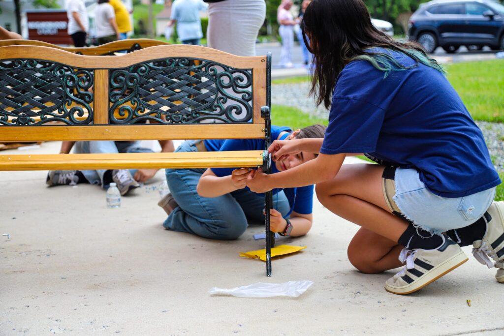 Students work together to build one of the benches for the pocket park
