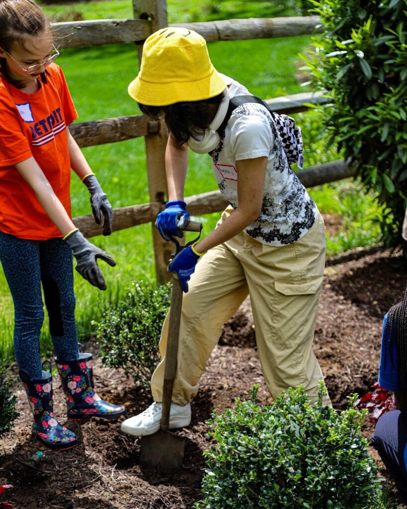 Students plant flowers and greenery