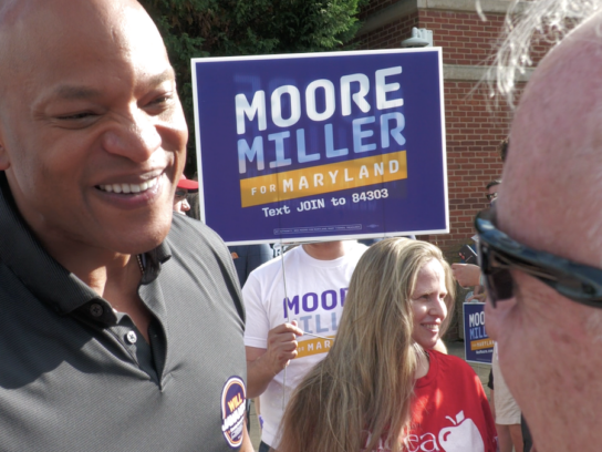 Gov. Moore with a voter at Lakelands Middle School in Gaithersburg. Photo credit: Markette Sheppard