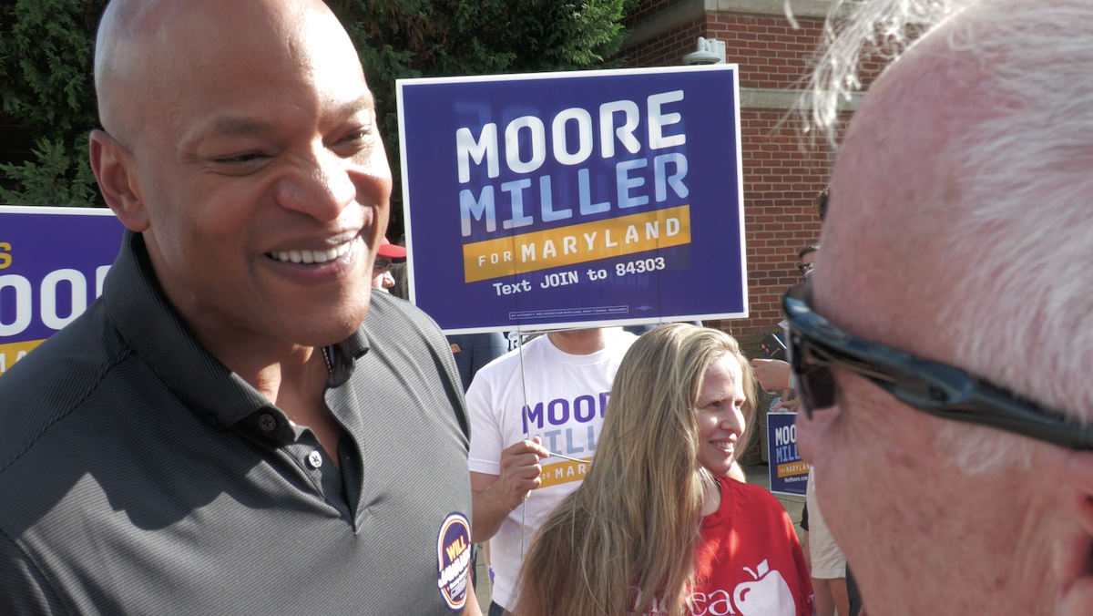Gov. Moore with a voter at Lakelands Middle School in Gaithersburg. Photo credit: Markette Sheppard