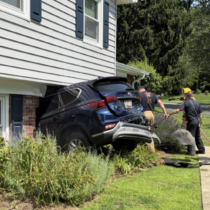 teen crashes into house