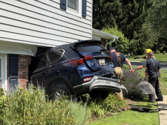 teen crashes into house