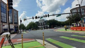 Bethesda Avenue intersection with traffic signals, pedestrians and green bike lane markings.