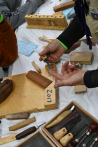 Scouts carve wood during a merit badge class at Alpha Merit Badge University at Morgan State University.