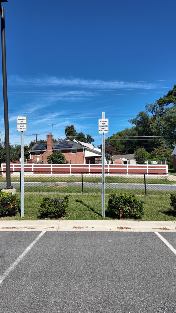 Empty parking spaces marked "Reserved for Foundation Staff" at Thomas Edison High School.