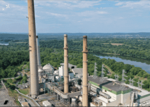 The plant’s smokestacks and industrial buildings sit near the Potomac River, raising questions about water use and environmental impact.